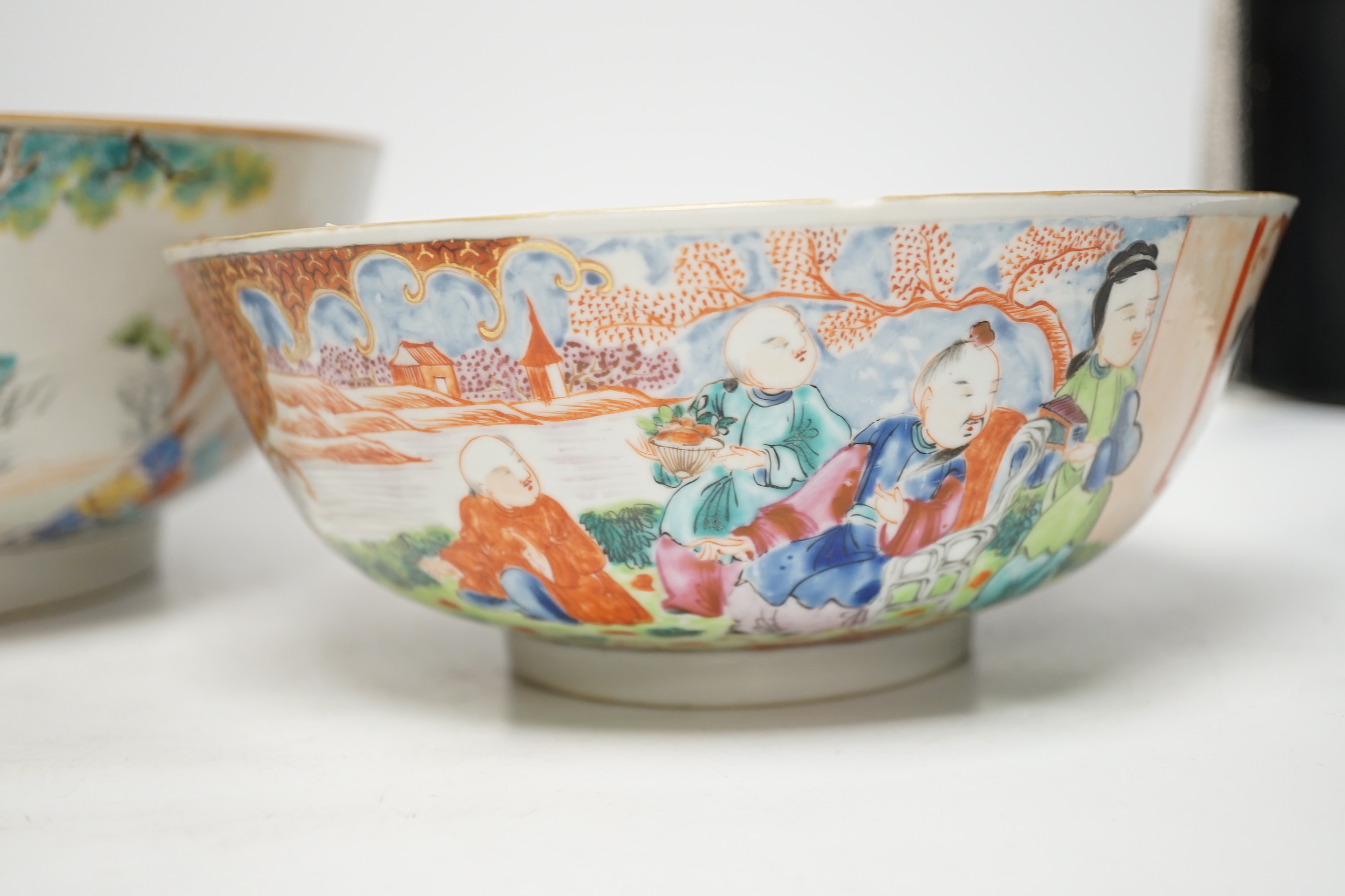 A Chinese famille rose bowl decorated with a dignitary and court figures (a.f.) and another smaller bowl, both Qianlong, largest 25cm in diameter